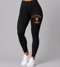 Black leggings with a logo on a gray background