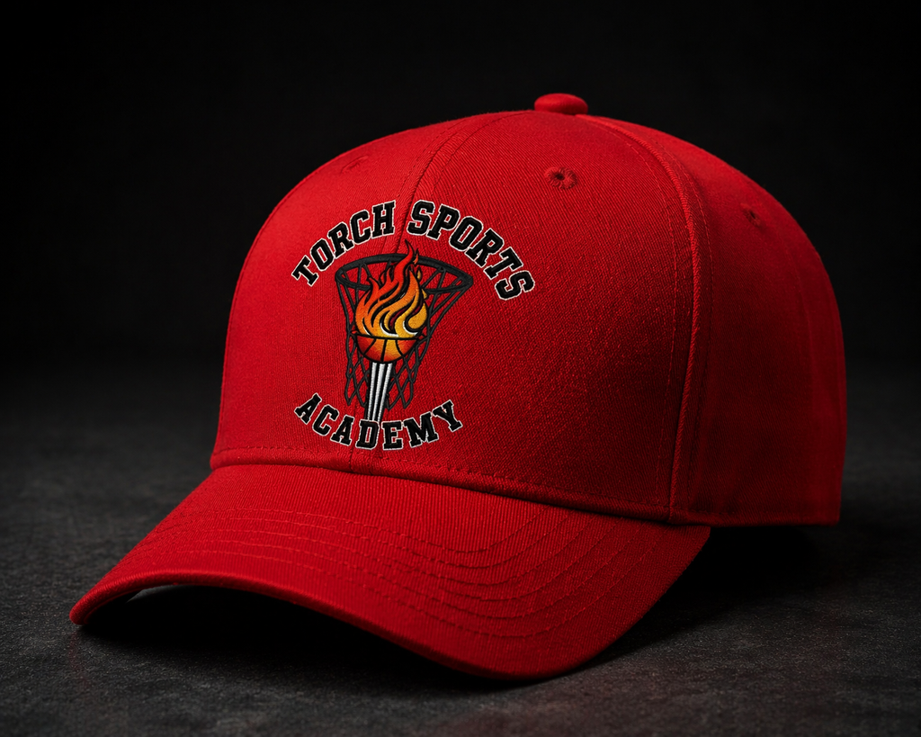 Red cap with 'Torch Sports Academy' logo on a dark background